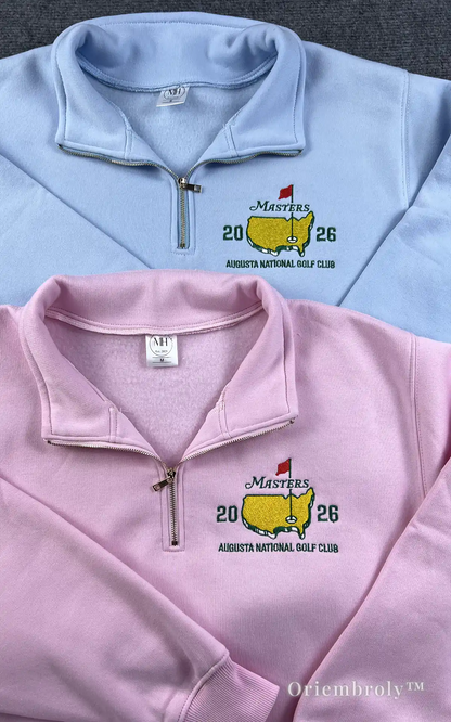 Vintage-inspired pink Masters 2026 embroidered sweatshirt. Features the iconic yellow map and red flag logo in a classic high-density satin stitch for a retro athletic feel