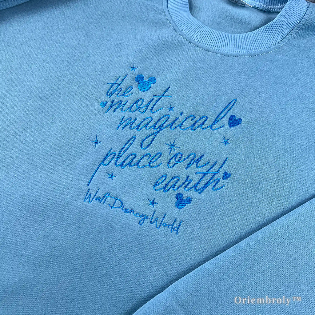 Unisex light blue Walt Disney World crewneck sweater featuring Mickey Mouse embroidery