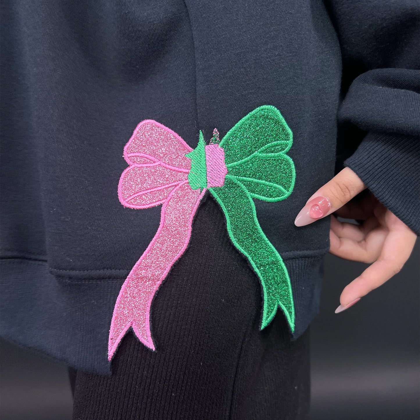 Wicked Defy Gravity embroidered sweatshirt with side bow embroidery, inspired by Glinda and Elphaba from the musical Wicked. Soft cotton hoodie with high-quality stitching