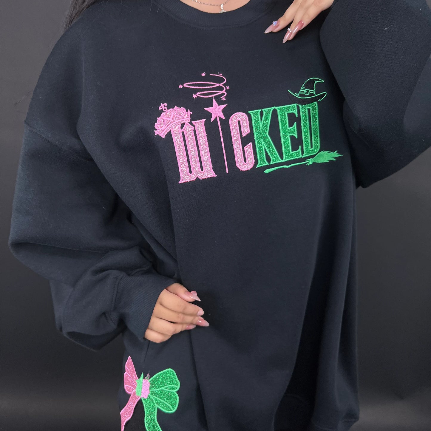 Wicked Defy Gravity embroidered sweatshirt with side bow embroidery, inspired by Glinda and Elphaba from the musical Wicked. Soft cotton hoodie with high-quality stitching