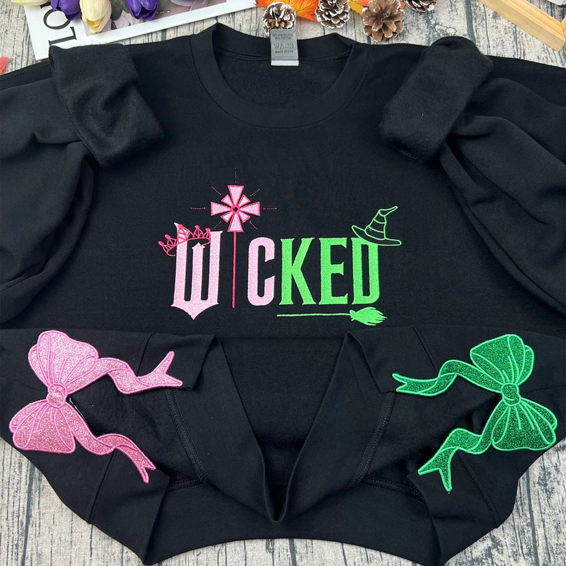 Wicked Glitter Embroidered Sweatshirt inspired by the musical Wicked, featuring appliqué embroidery, perfect for Wizard of Oz and Defying Gravity fans.