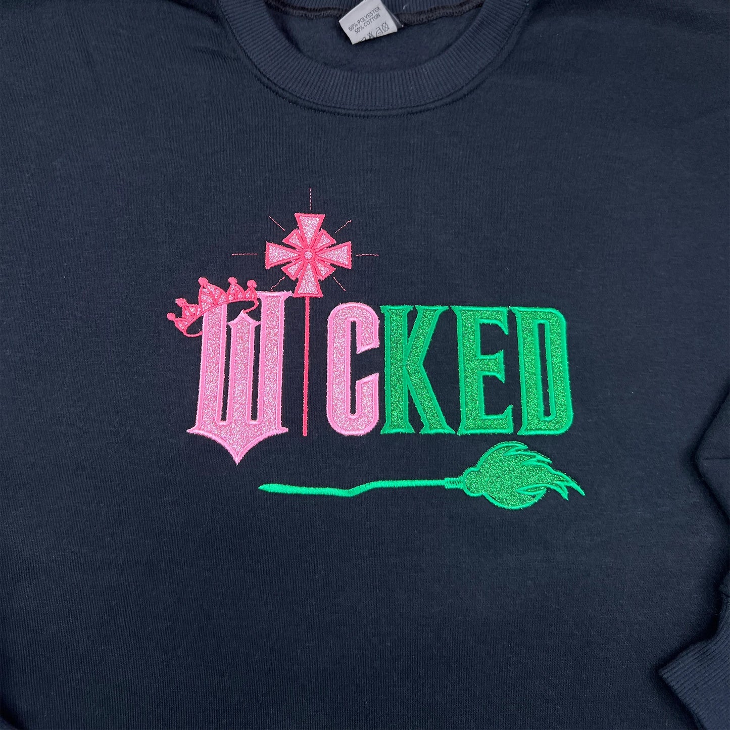 Wicked Movie embroidered sweatshirt featuring Defying Gravity design, side bow embroidery, and inspired by Glinda and Elphaba. Cozy and stylish for Broadway fans.