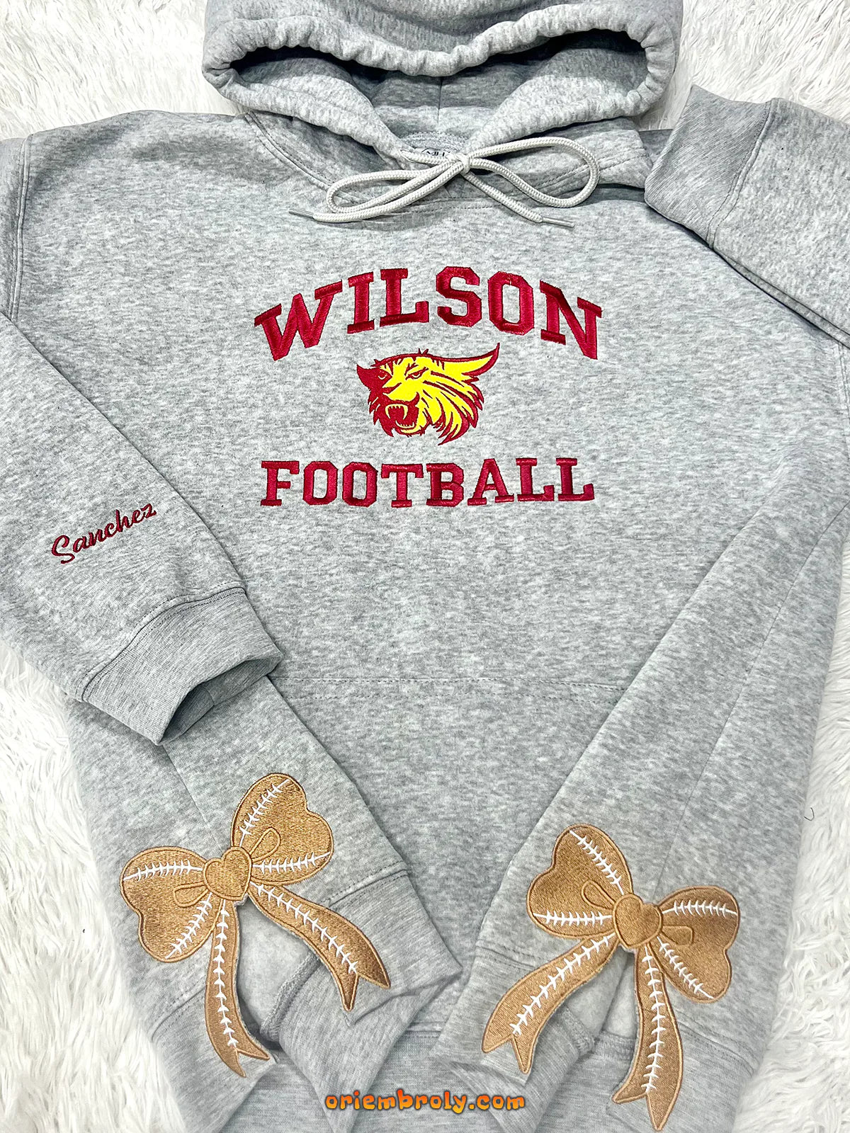 Gray hoodie with 'Wilson Football' text and logo on a white background