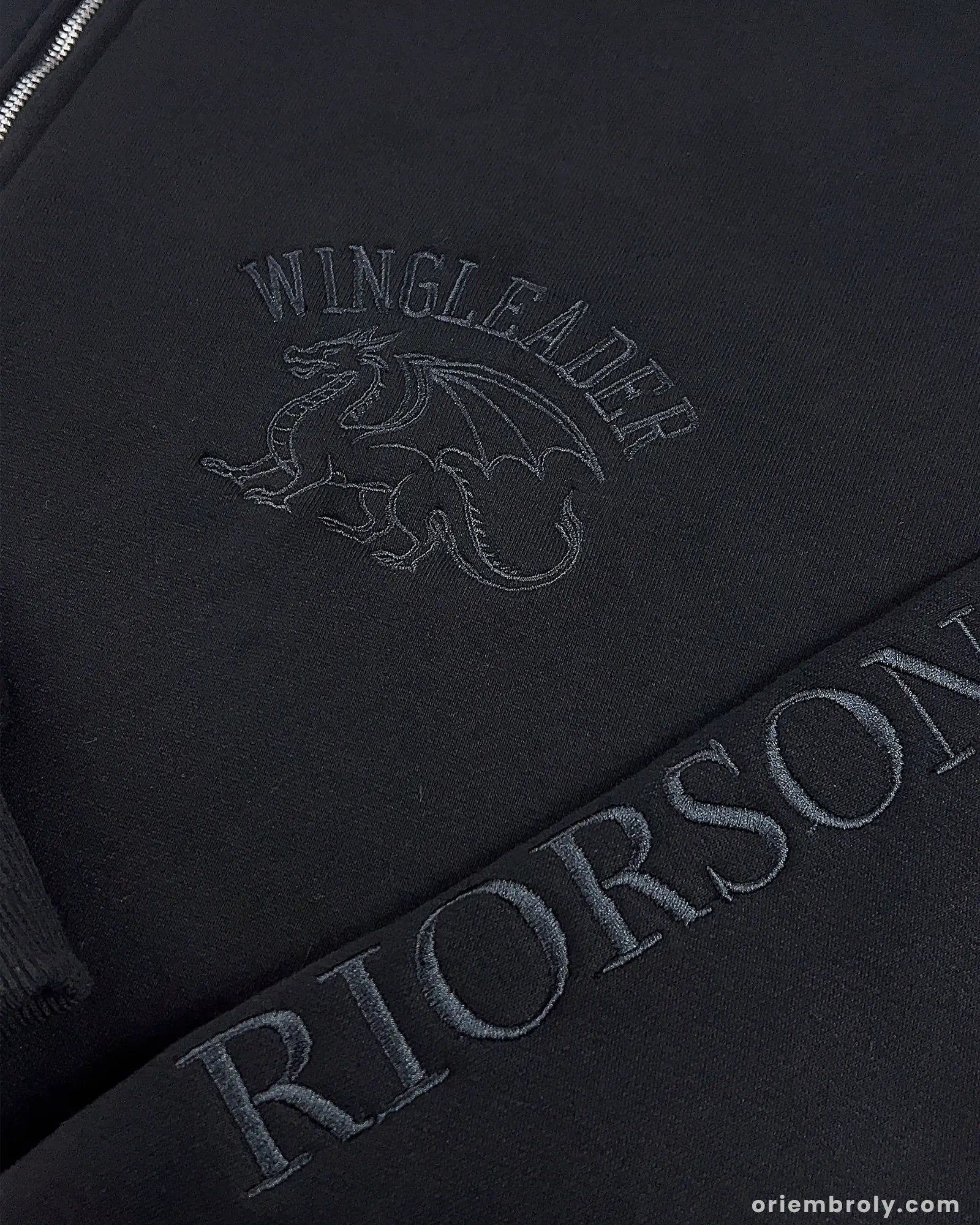 Close-up of Wingleader dragon embroidery on left chest
