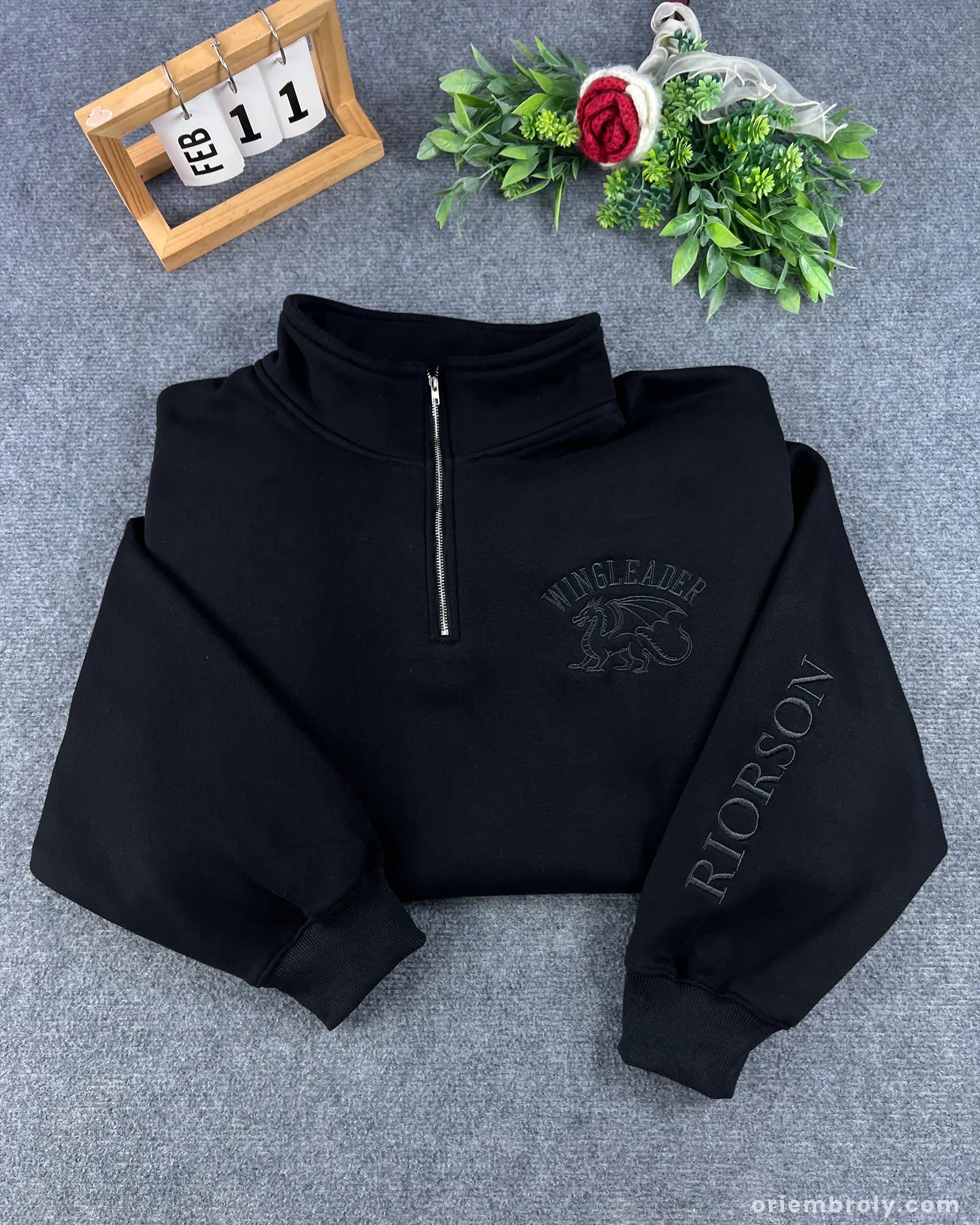 Metallic gold dragon embroidery on black quarter zip