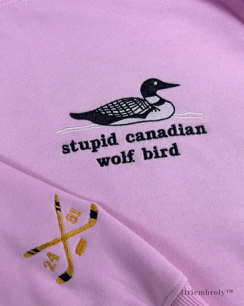 Black and white loon bird embroidery detail on crewneck