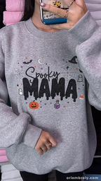 Model wearing an oversized gray Spooky MAMA embroidered sweatshirt indoors.