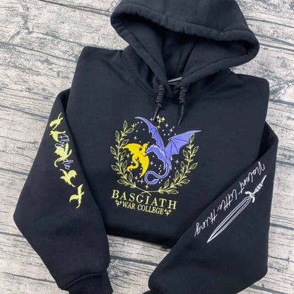 Black hoodie with dragon design and text on a wooden surface